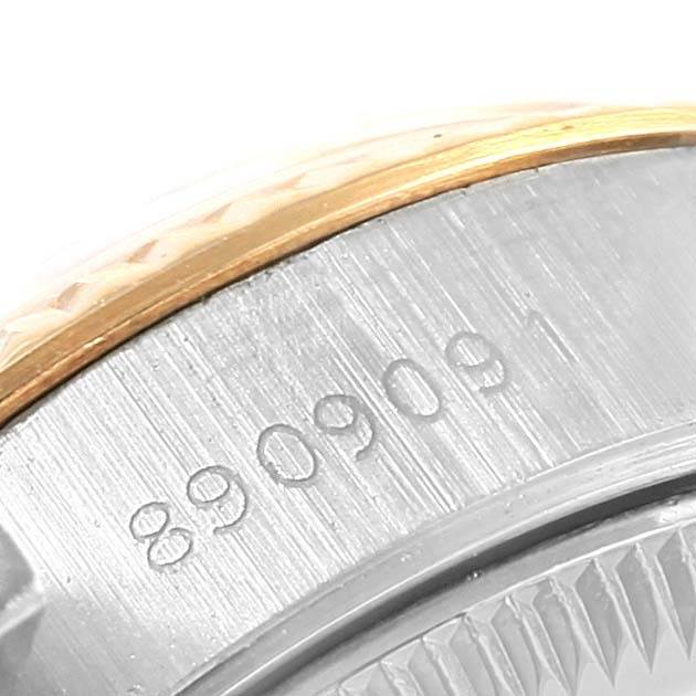 This image shows a close-up of the serial number and part of the bezel of a Rolex Datejust 69163 Women's Stainless Steel Champagne Dial 69163 Women's Stainless Steel Champagne Dial watch.