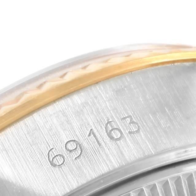 This close-up image shows the side of a Rolex Datejust 69163 Women's Stainless Steel Champagne Dial 69163 Women's Stainless Steel Champagne Dial watch case with the model number 69163 engraved.