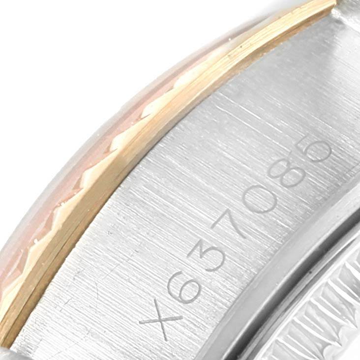 This image shows a close-up of the serial number on the bezel and case of a Rolex Datejust 69173 Women's Stainless Steel Blue Dial 69173 Women's Stainless Steel Blue Dial watch.