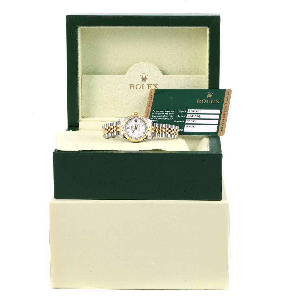 The image shows a Rolex Datejust 179173 Women's Steel and Gold (two tone) White Dial 179173 Women's Steel and Gold (two tone) White Dial watch placed inside its green open box alongside its certification card.