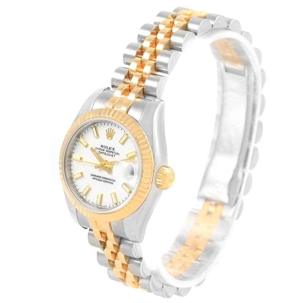 The image shows a Rolex Datejust 179173 Women's Steel and Gold (two tone) White Dial 179173 Women's Steel and Gold (two tone) White Dial watch from an angled side view, highlighting its face, bezel, crown, and bracelet.