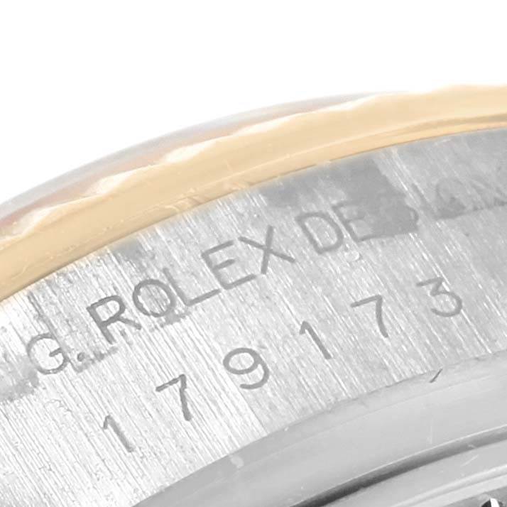 This close-up image shows part of the case-back engraving of a Rolex Datejust 179173 Women's Steel and Gold (two tone) White Dial 179173 Women's Steel and Gold (two tone) White Dial watch, including the serial and model numbers.