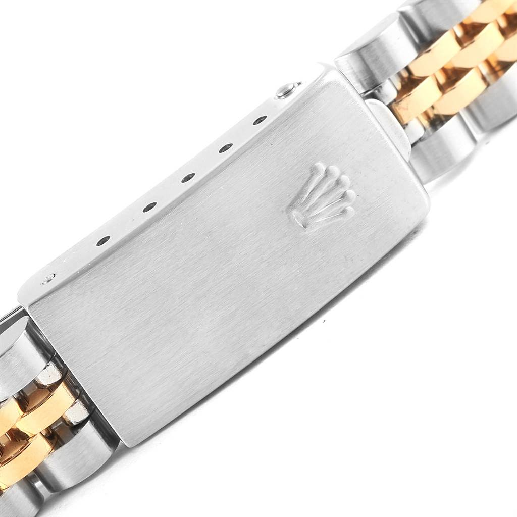 The image shows a close-up of the clasp on a Rolex Datejust 69173 Women's Stainless Steel White Dial 69173 Women's Stainless Steel White Dial watch bracelet with the brand's logo engraved.