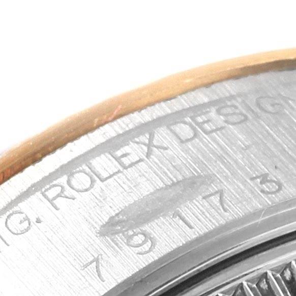This close-up image of a Rolex Datejust 79173 Women's Stainless Steel Black Dial 79173 Women's Stainless Steel Black Dial watch focuses on the engraved bezel showing part of the brand's name and model details.