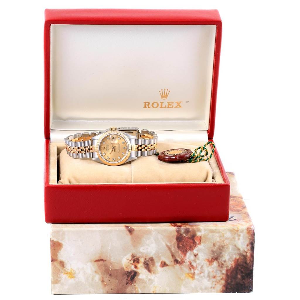 The image shows a Rolex Datejust 69173 Women's Stainless Steel Champagne Dial 69173 Women's Stainless Steel Champagne Dial watch positioned inside its open display box, along with a tag accessory.