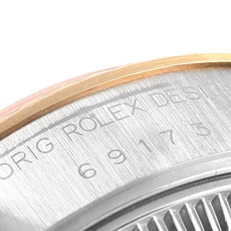This image shows a close-up angle of the engraved case back and part of the bezel of a Rolex Datejust 69173 Women's Stainless Steel Champagne Dial 69173 Women's Stainless Steel Champagne Dial watch.