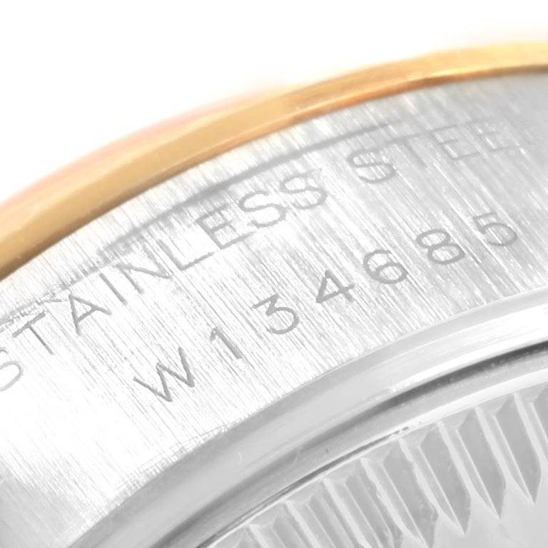 The image shows a close-up angle of the Rolex Datejust 69173 Women's Stainless Steel Champagne Dial 69173 Women's Stainless Steel Champagne Dial, focusing on the stainless steel case with engraved text and numbers.