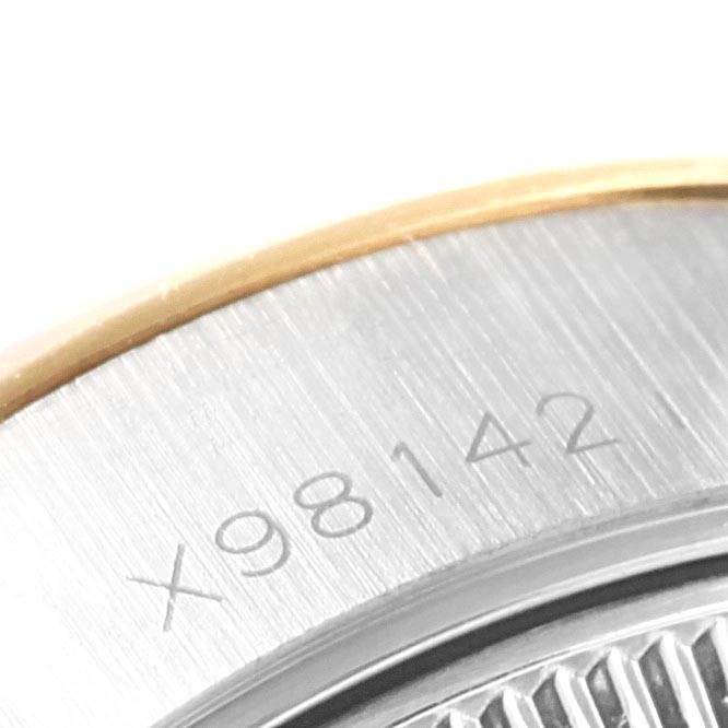 This close-up image shows the serial number engraving on the side of the Rolex Datejust 69173 Women's Stainless Steel Beige Dial 69173 Women's Stainless Steel Beige Dial watch case.