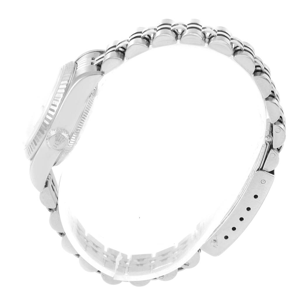 The image shows a side profile of a Rolex Datejust 79174 Women's Stainless Steel White Dial 79174 Women's Stainless Steel White Dial watch focusing on its case, crown, and band.