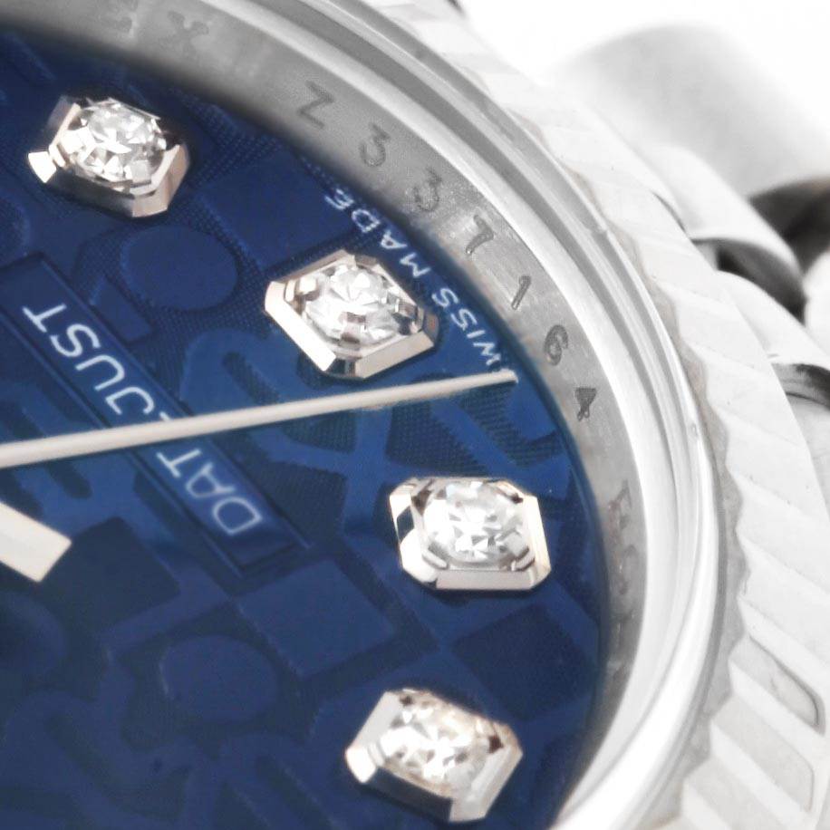 This close-up shows the dial, bezel, and part of the bracelet of the Rolex Datejust 179174 Women's Stainless Steel Blue Dial 179174 Women's Stainless Steel Blue Dial watch.