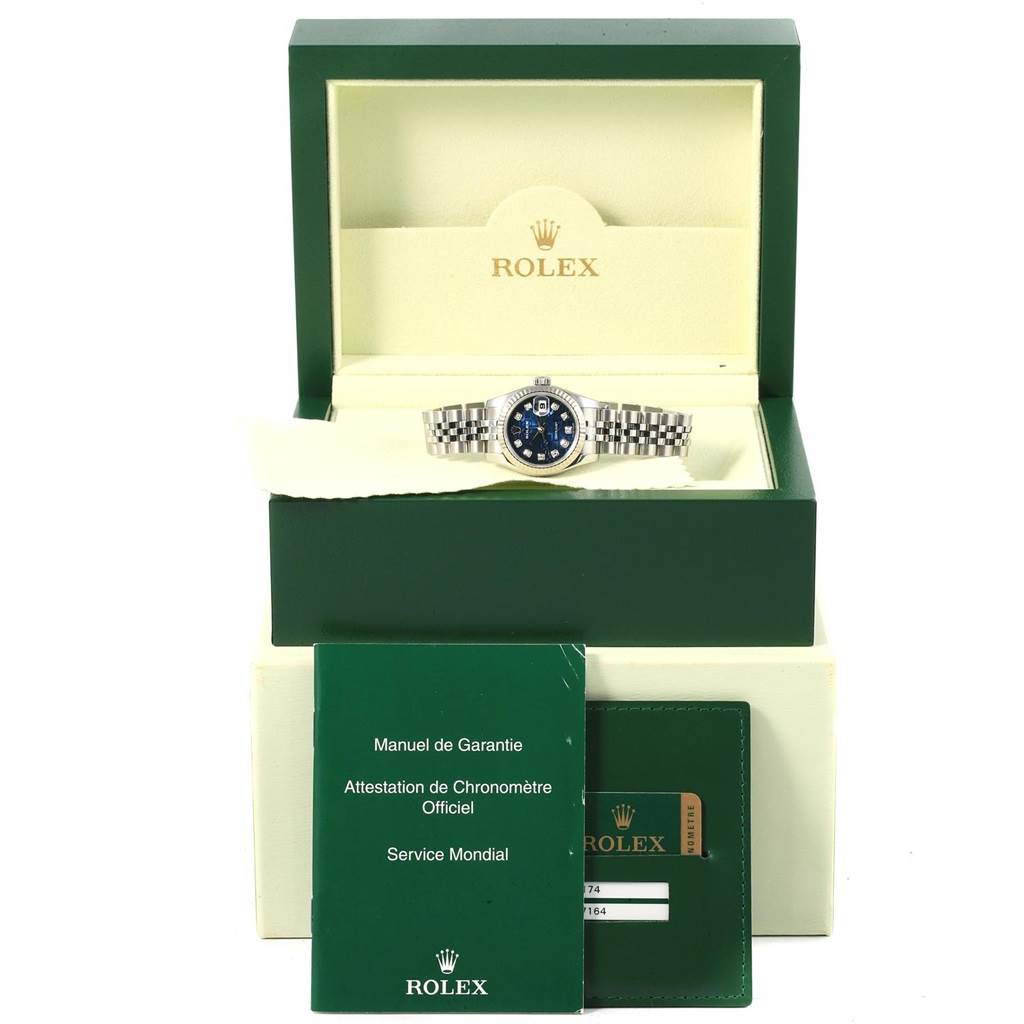 The image shows a Rolex Datejust 179174 Women's Stainless Steel Blue Dial 179174 Women's Stainless Steel Blue Dial watch in a green case, along with accompanying warranty and service manuals.