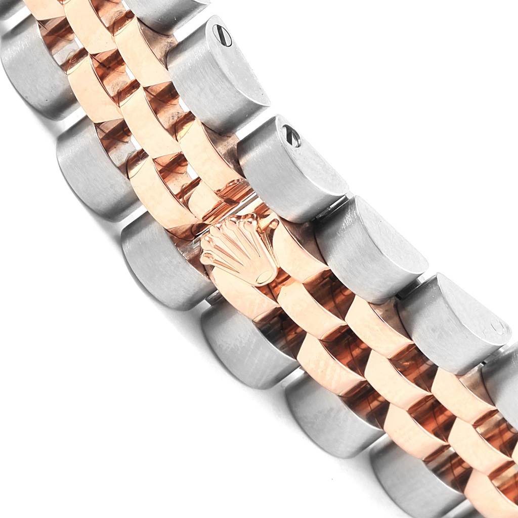 This image shows a close-up of the two-tone bracelet from a Rolex Datejust 179171 Women
s Steel and Gold (two tone) Pink Dial 179171 Women
s Steel and Gold (two tone) Pink Dial watch, featuring the brand
s crown logo on a link.