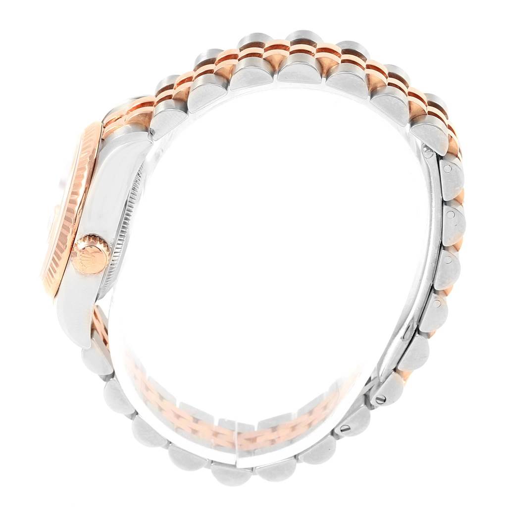 This side view of the Rolex Datejust 179171 Women
s Steel and Gold (two tone) Pink Dial 179171 Women
s Steel and Gold (two tone) Pink Dial watch showcases the bezel, crown, and two-tone bracelet.