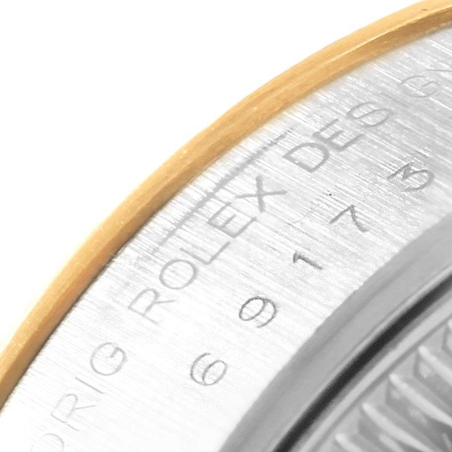 This close-up image shows the side engraving "ROLEX" on the bezel of a Rolex Datejust 69173 Women's Stainless Steel Champagne Dial 69173 Women's Stainless Steel Champagne Dial watch.