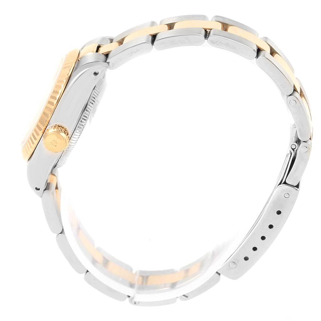 The image shows a side view of the Rolex Datejust 69173 Women
s Stainless Steel White Dial 69173 Women
s Stainless Steel White Dial watch, highlighting its crown, case, and two-tone bracelet.