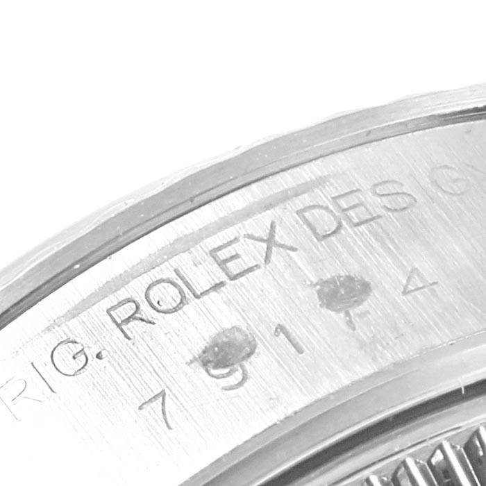 The image shows an angled, close-up view of the engraved case back of a Rolex Datejust 79174 Women's Stainless Steel Blue Dial 79174 Women's Stainless Steel Blue Dial watch.