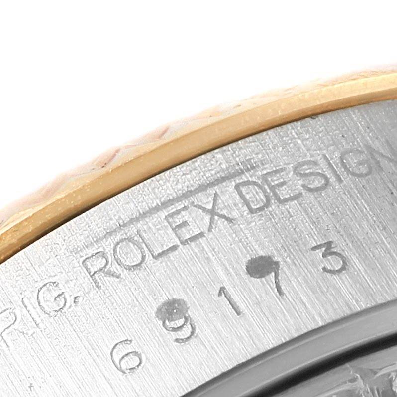 The image shows a close-up of the bezel and case of a Rolex Datejust 69173 Women's Stainless Steel White Dial 69173 Women's Stainless Steel White Dial, highlighting the model engraving.