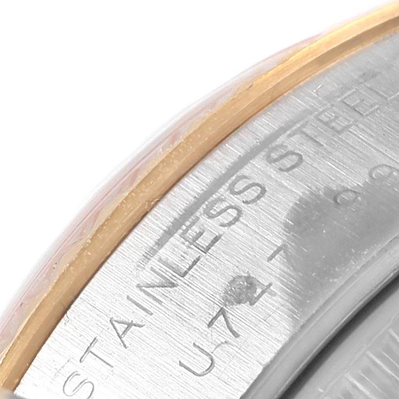 This close-up shows the edge of the metal case back of a Rolex Datejust 69173 Women's Stainless Steel White Dial 69173 Women's Stainless Steel White Dial watch, engraved with "STAINLESS STEEL."