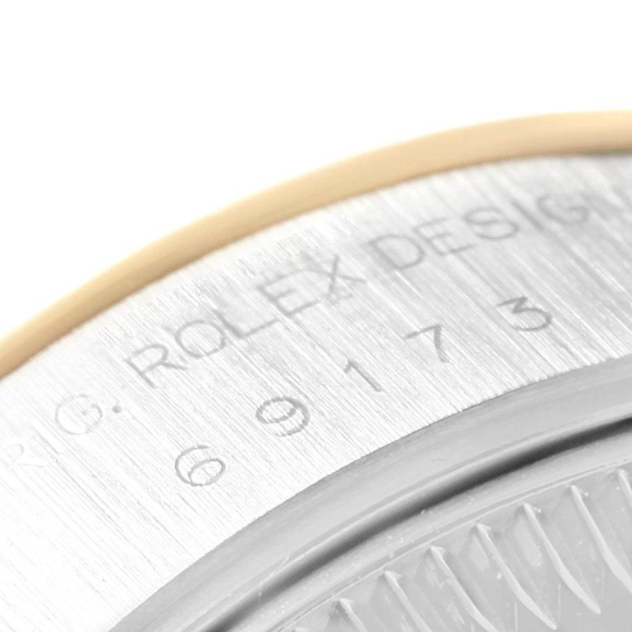 This close-up image shows the engraved serial number on the case back edge of a Rolex Datejust 69173 Women's Stainless Steel Silver Dial 69173 Women's Stainless Steel Silver Dial watch.