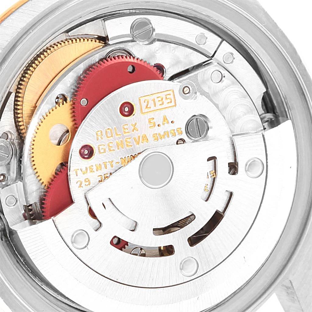 The image shows an internal view of a Rolex Datejust 69173 Women's Stainless Steel Silver Dial 69173 Women's Stainless Steel Silver Dial watch, focusing on the movement mechanism and gears.