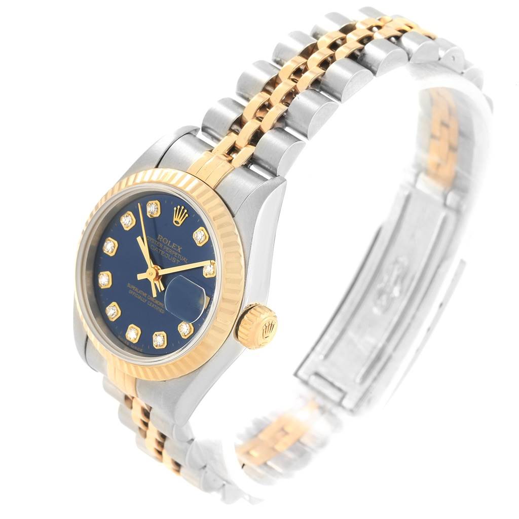 The image shows a Rolex Datejust 69173 Women's Stainless Steel Blue Dial 69173 Women's Stainless Steel Blue Dial watch from a three-quarter perspective, highlighting the blue dial, gold fluted bezel, and two-tone bracelet.