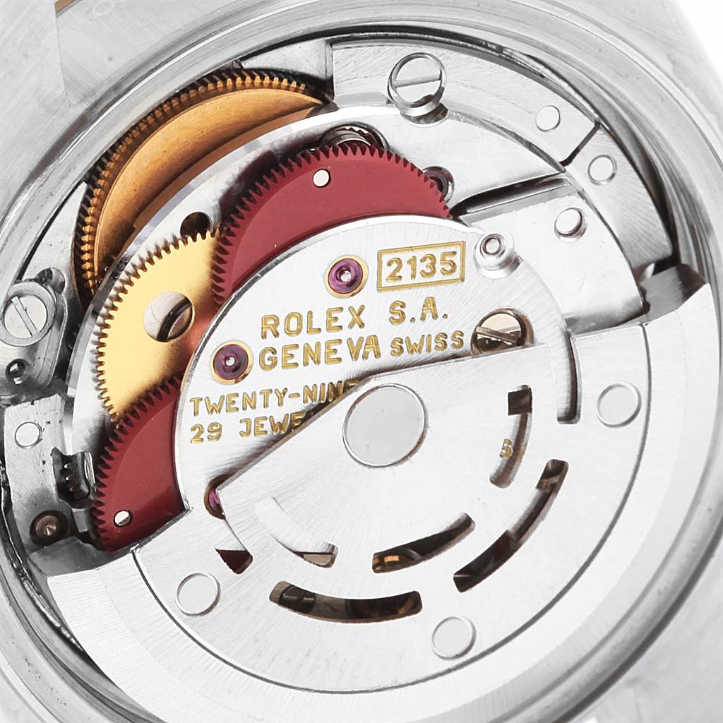 The image shows a close-up view of the internal mechanism of a Rolex Datejust 69173 Women's Stainless Steel Blue Dial 69173 Women's Stainless Steel Blue Dial watch, highlighting gears and components.