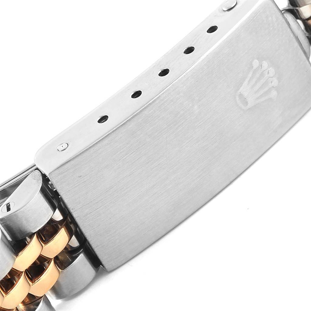 This image shows the clasp of a Rolex Datejust 69173 Women's Stainless Steel Blue Dial 69173 Women's Stainless Steel Blue Dial watch, including part of its metal bracelet and the Rolex crown logo.