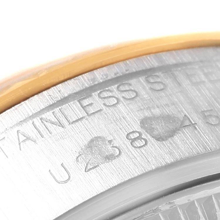 This close-up image shows the edge of the stainless steel case on a Rolex Datejust 69173 Women's Stainless Steel Blue Dial 69173 Women's Stainless Steel Blue Dial watch, highlighting its engraving.