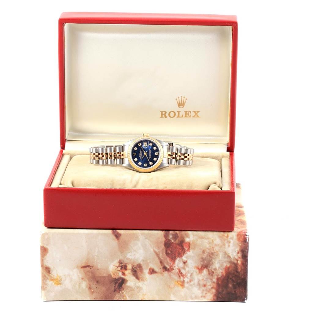 The image shows a Rolex Datejust 69173 Women's Stainless Steel Blue Dial 69173 Women's Stainless Steel Blue Dial watch with a jubilee bracelet and blue dial, presented in an open red box.