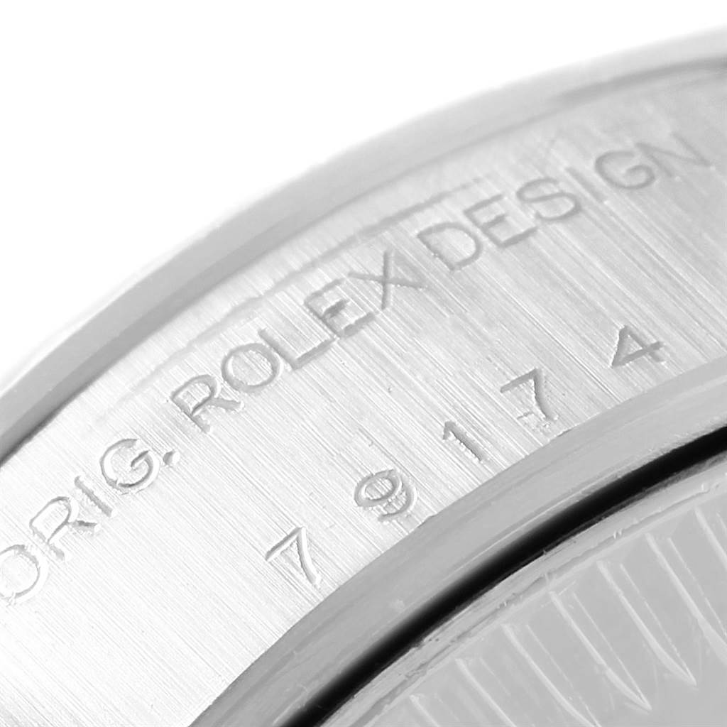 The image shows a close-up of the engraved bezel on a Rolex Datejust 79174 Women
s Stainless Steel Mother of Pearl Dial 79174 Women
s Stainless Steel Mother of Pearl Dial watch.