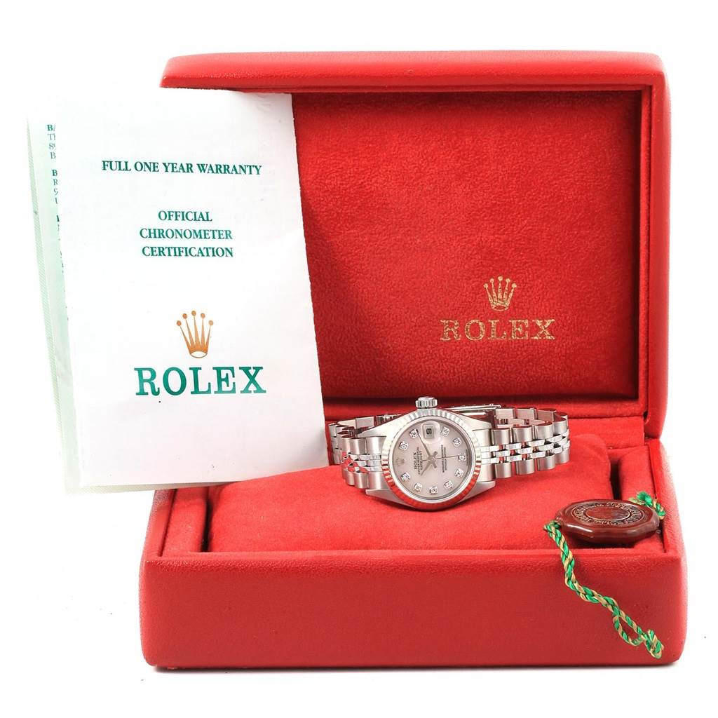The Rolex Datejust 79174 Women
s Stainless Steel Mother of Pearl Dial 79174 Women
s Stainless Steel Mother of Pearl Dial watch is shown in a red box with warranty papers and a tag beside it.