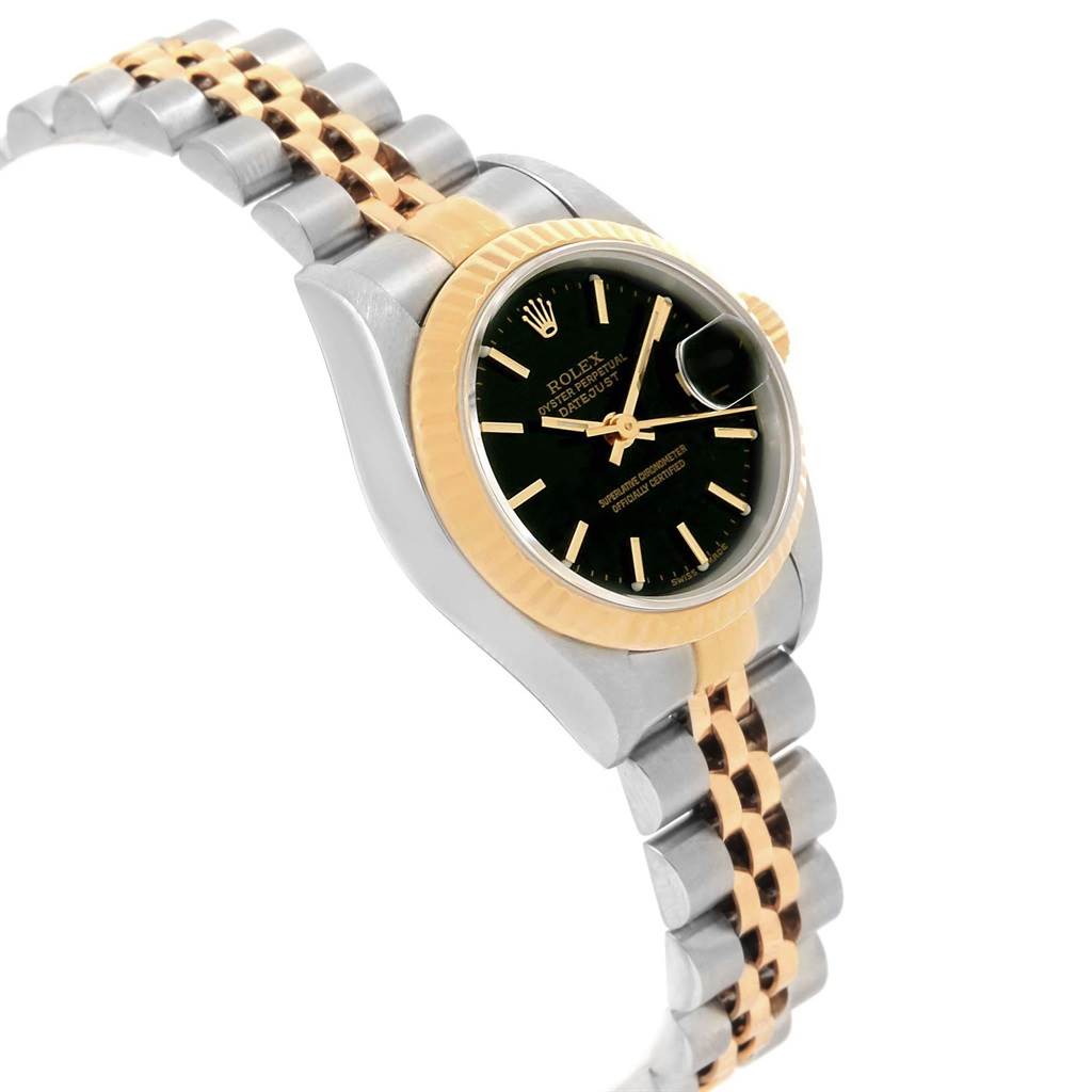 The image shows a Rolex Datejust 79173 Women
s Steel and Gold (two tone) Black Dial 79173 Women
s Steel and Gold (two tone) Black Dial watch at a slight angle, highlighting its two-tone bracelet, black dial, and fluted bezel.