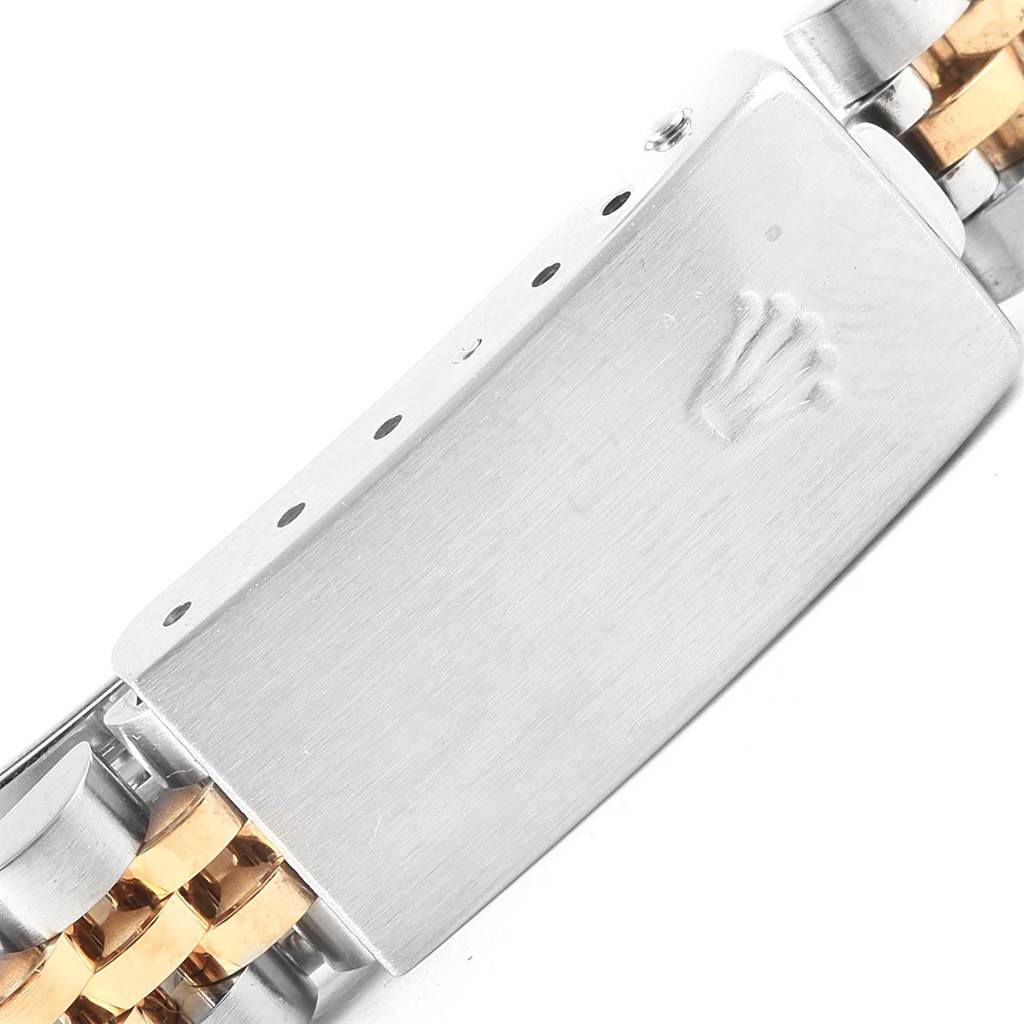 The image shows a close-up of the clasp on a Rolex Datejust 79173 Women
s Steel and Gold (two tone) Black Dial 79173 Women
s Steel and Gold (two tone) Black Dial model watch bracelet.