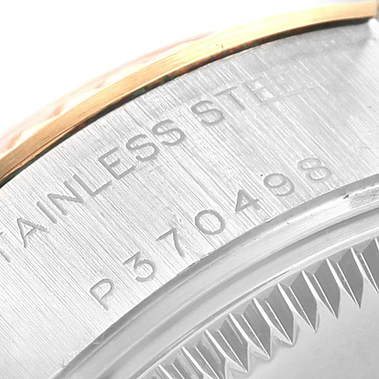 This close-up image shows the serial number and part of the case back of a Rolex Datejust 79173 Women
s Steel and Gold (two tone) Black Dial 79173 Women
s Steel and Gold (two tone) Black Dial watch.