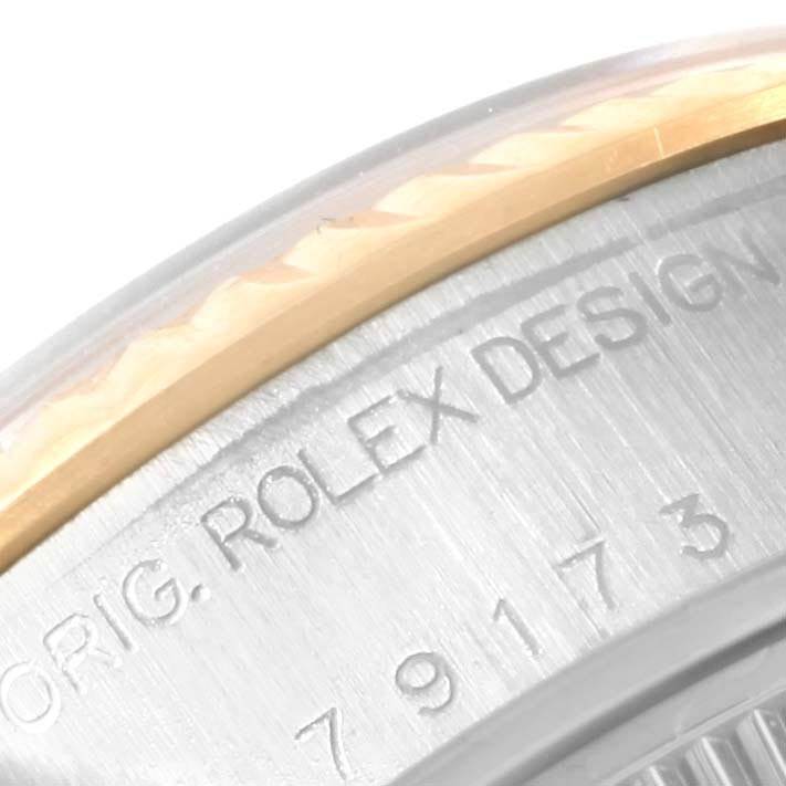 The image shows a close-up of the engraved bezel and casing of the Rolex Datejust 79173 Women
s Steel and Gold (two tone) Black Dial 79173 Women
s Steel and Gold (two tone) Black Dial model.