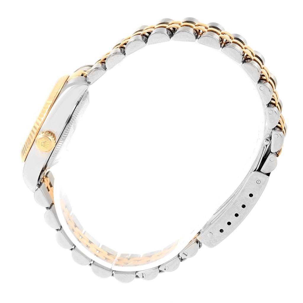 This image shows a side profile of a Rolex Datejust 79173 Women's Steel and Gold (two tone) Silver Dial 79173 Women's Steel and Gold (two tone) Silver Dial watch, highlighting its metal case, crown, and two-tone bracelet.