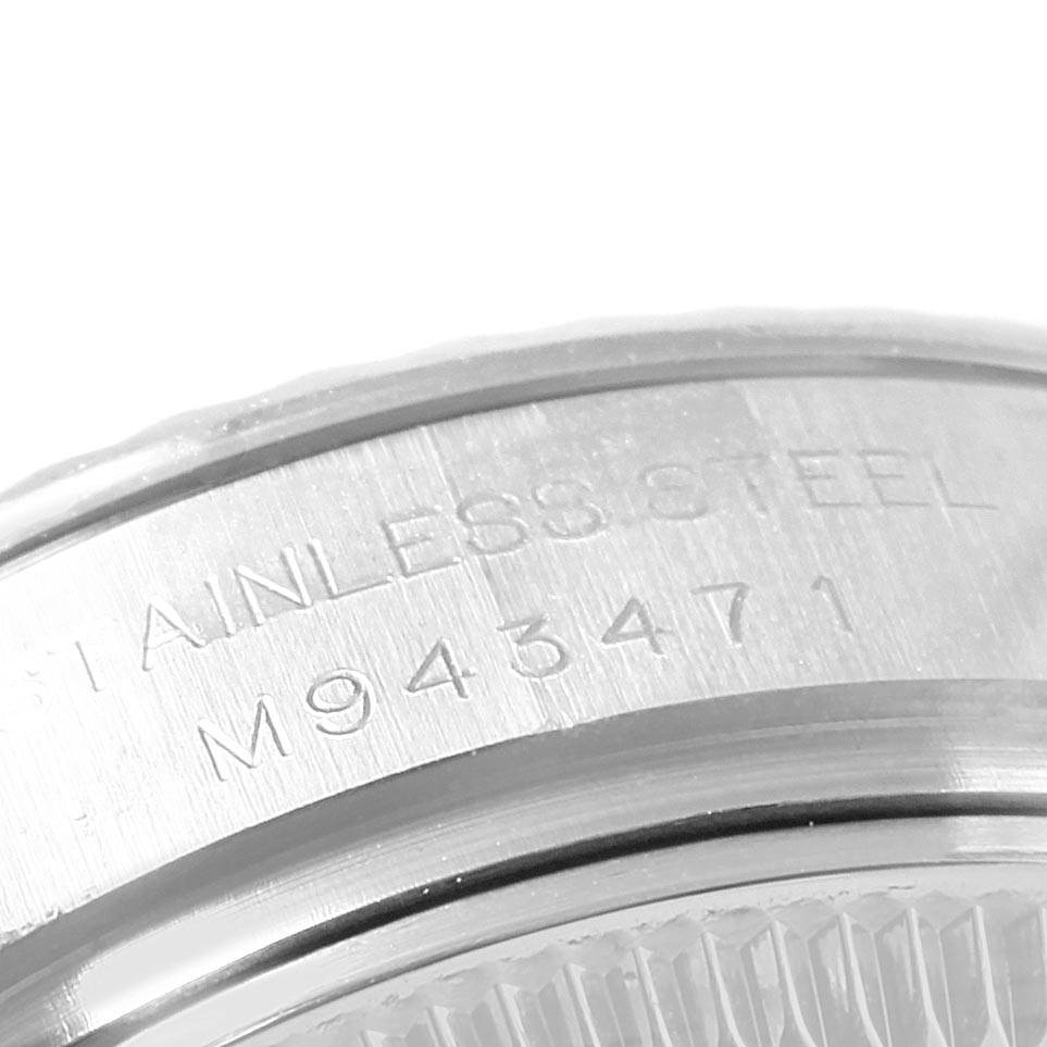 This image shows a close-up of the stainless steel case back and part of the bezel of a Rolex Datejust 179174 Women's Stainless Steel Silver Dial 179174 Women's Stainless Steel Silver Dial watch.