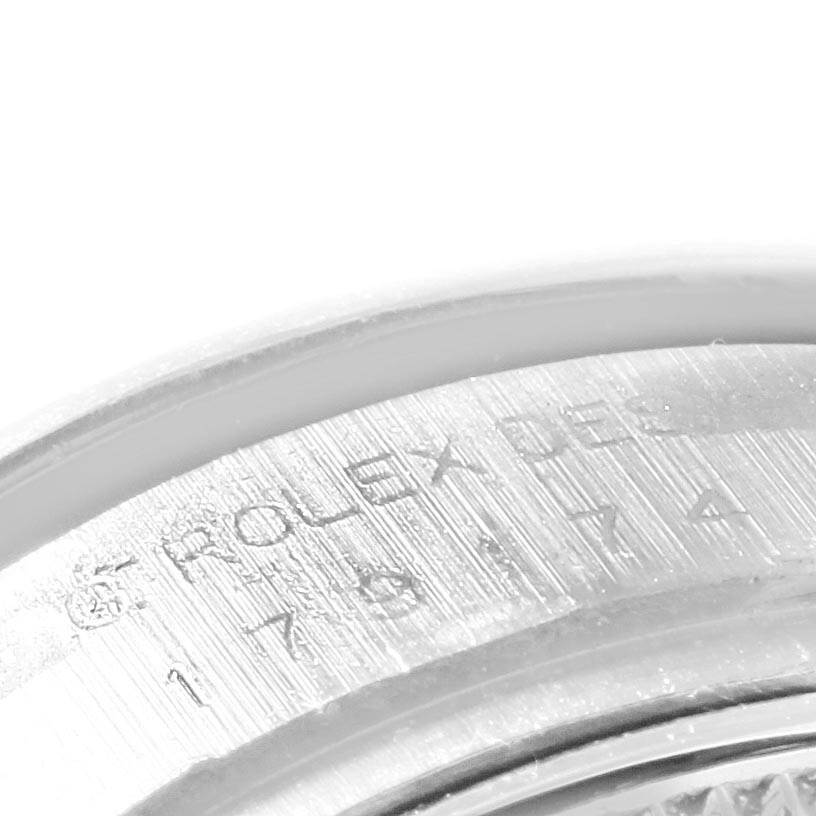 The image shows a close-up of the engraved text on the inner bezel of a Rolex Datejust 179174 Women
s Stainless Steel Mother of Pearl Dial 179174 Women
s Stainless Steel Mother of Pearl Dial watch.