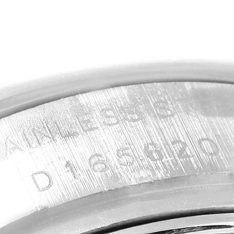 The image shows an extreme close-up of the serial number engraved on the case back of a Rolex Datejust 179174 Women
s Stainless Steel Mother of Pearl Dial 179174 Women
s Stainless Steel Mother of Pearl Dial watch.