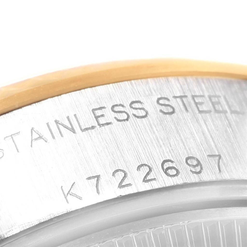 The image shows the side engraving of a Rolex Datejust 79173 Women
s Stainless Steel Blue Dial 79173 Women
s Stainless Steel Blue Dial model watch, displaying "STAINLESS STEEL" and a serial number.