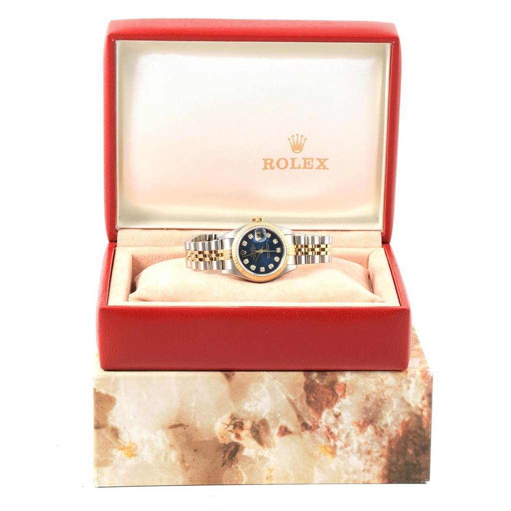 The image shows a Rolex Datejust 79173 Women
s Stainless Steel Blue Dial 79173 Women
s Stainless Steel Blue Dial watch, displayed open-faced in its red case with a cushioned interior.