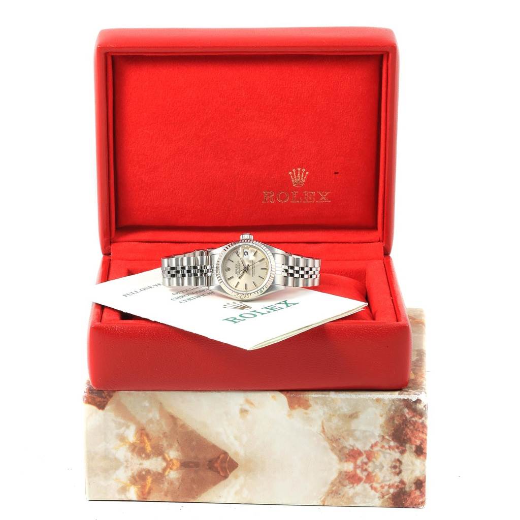 The Rolex Datejust 69174 Women's Stainless Steel Silver Dial 69174 Women's Stainless Steel Silver Dial watch is shown in a frontal angle inside an open red box with a visible booklet.