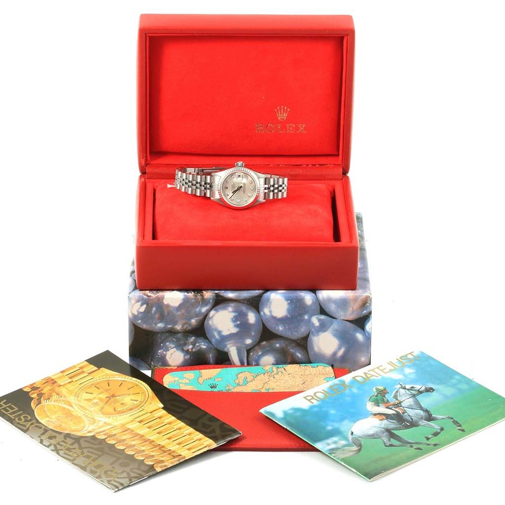 The image shows a Rolex Datejust 79174 Women's Stainless Steel Silver Dial 79174 Women's Stainless Steel Silver Dial watch in a red box with accompanying booklets and packaging.