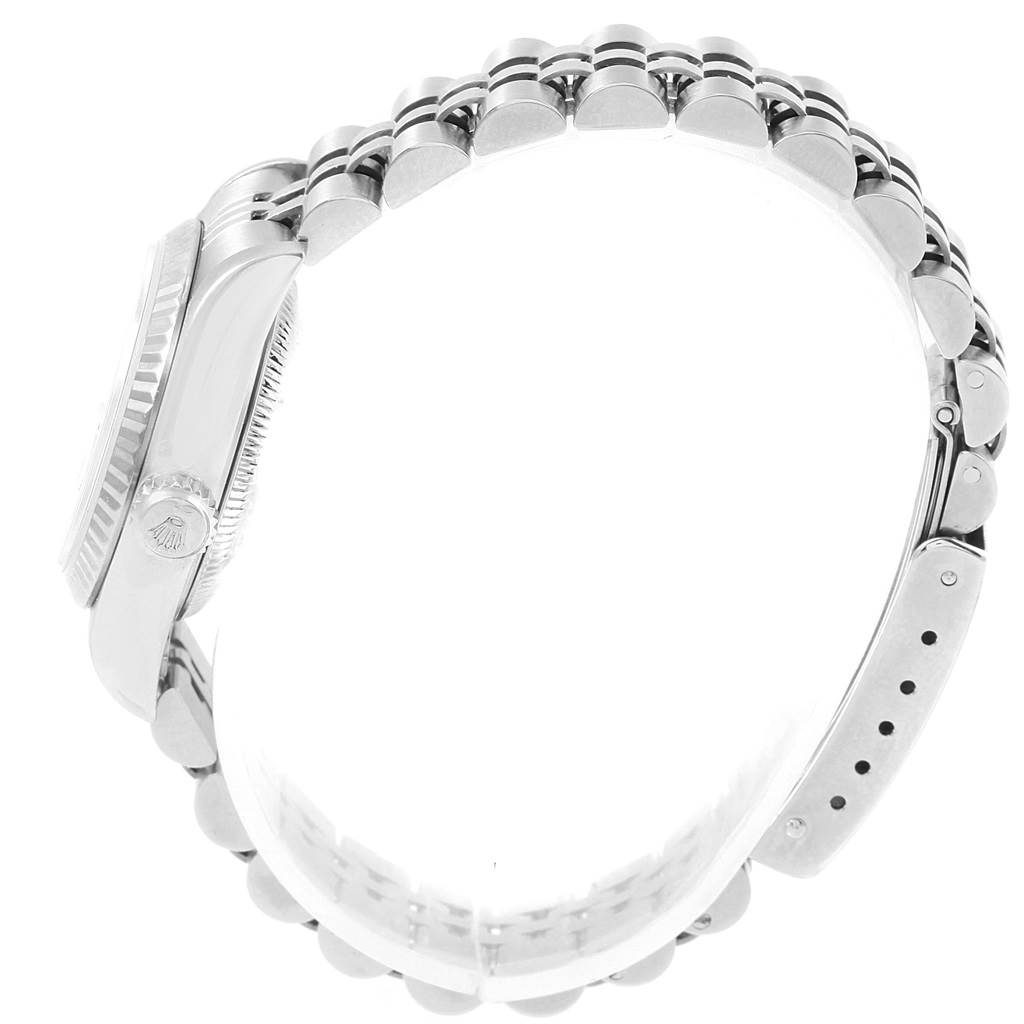 The image shows a side view of the Rolex Datejust 79174 Women's Stainless Steel Silver Dial 79174 Women's Stainless Steel Silver Dial watch, highlighting the bezel, crown, and bracelet.