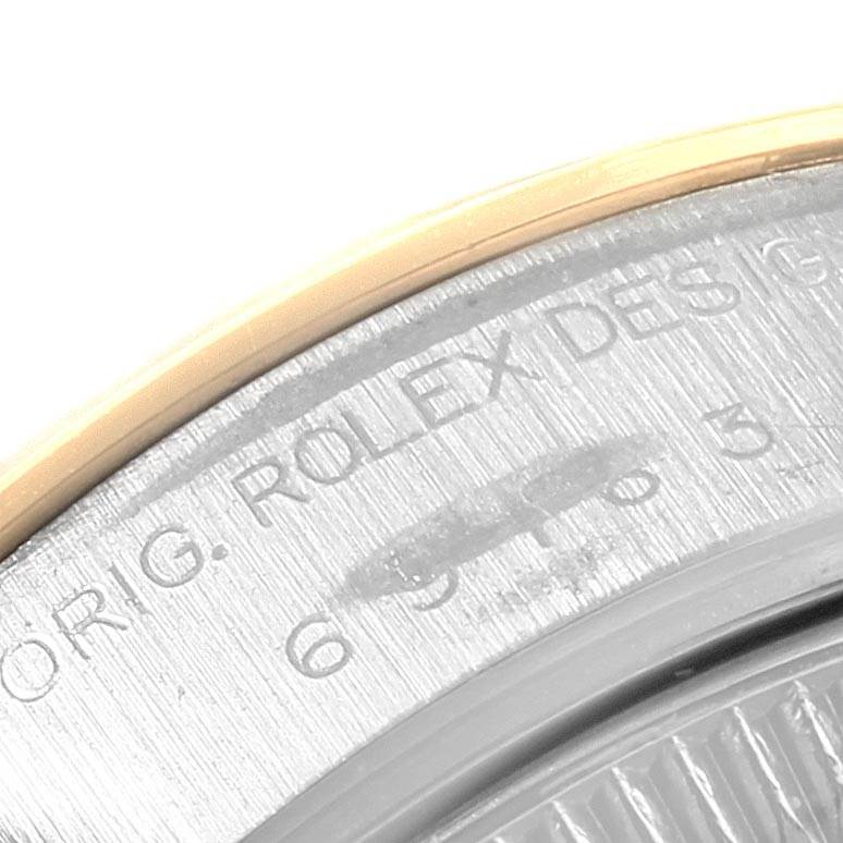 This close-up image of a Rolex Datejust 69163 Women's Stainless Steel Grey Dial 69163 Women's Stainless Steel Grey Dial watch shows a partial view of the case back and the engraved text on the metal surface.