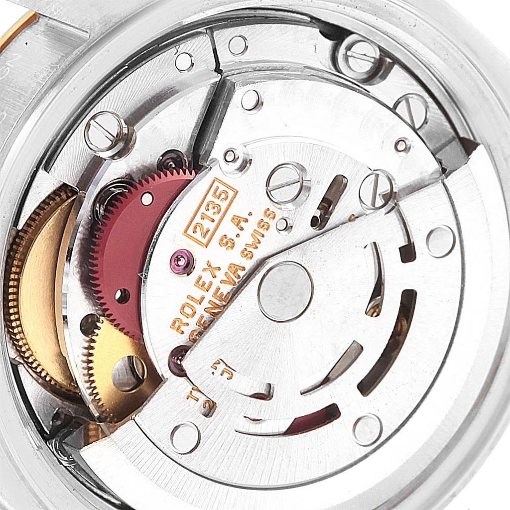 The image shows the intricate inner mechanism of a Rolex Datejust 69173 Women's Stainless Steel Champagne Dial 69173 Women's Stainless Steel Champagne Dial watch, highlighting gears and the automatic movement serial number 2135.