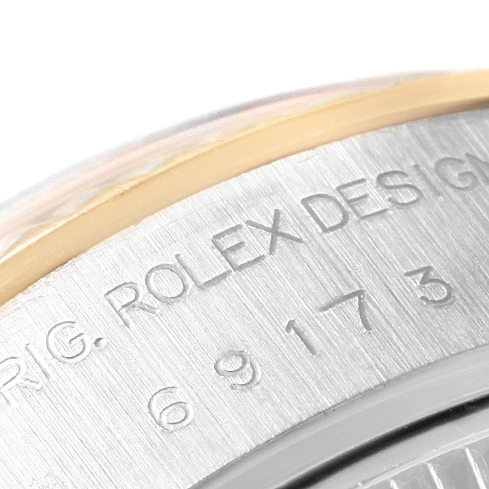 This close-up image shows the engraved details on the side of the case of a Rolex Datejust 69173 Women's Stainless Steel Champagne Dial 69173 Women's Stainless Steel Champagne Dial watch.