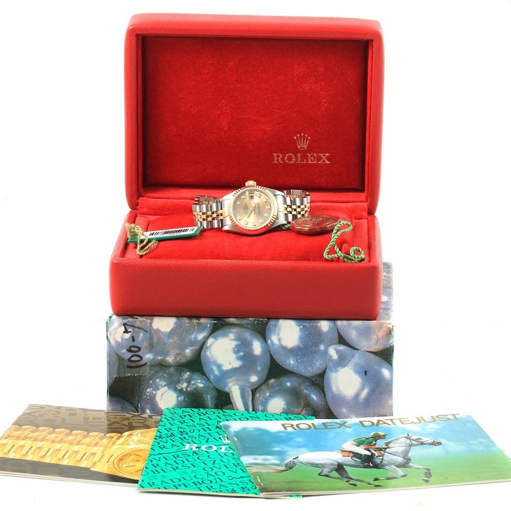 The image shows a Rolex Datejust 69173 Women's Stainless Steel Champagne Dial 69173 Women's Stainless Steel Champagne Dial watch in a red case with accompanying booklets and tags.