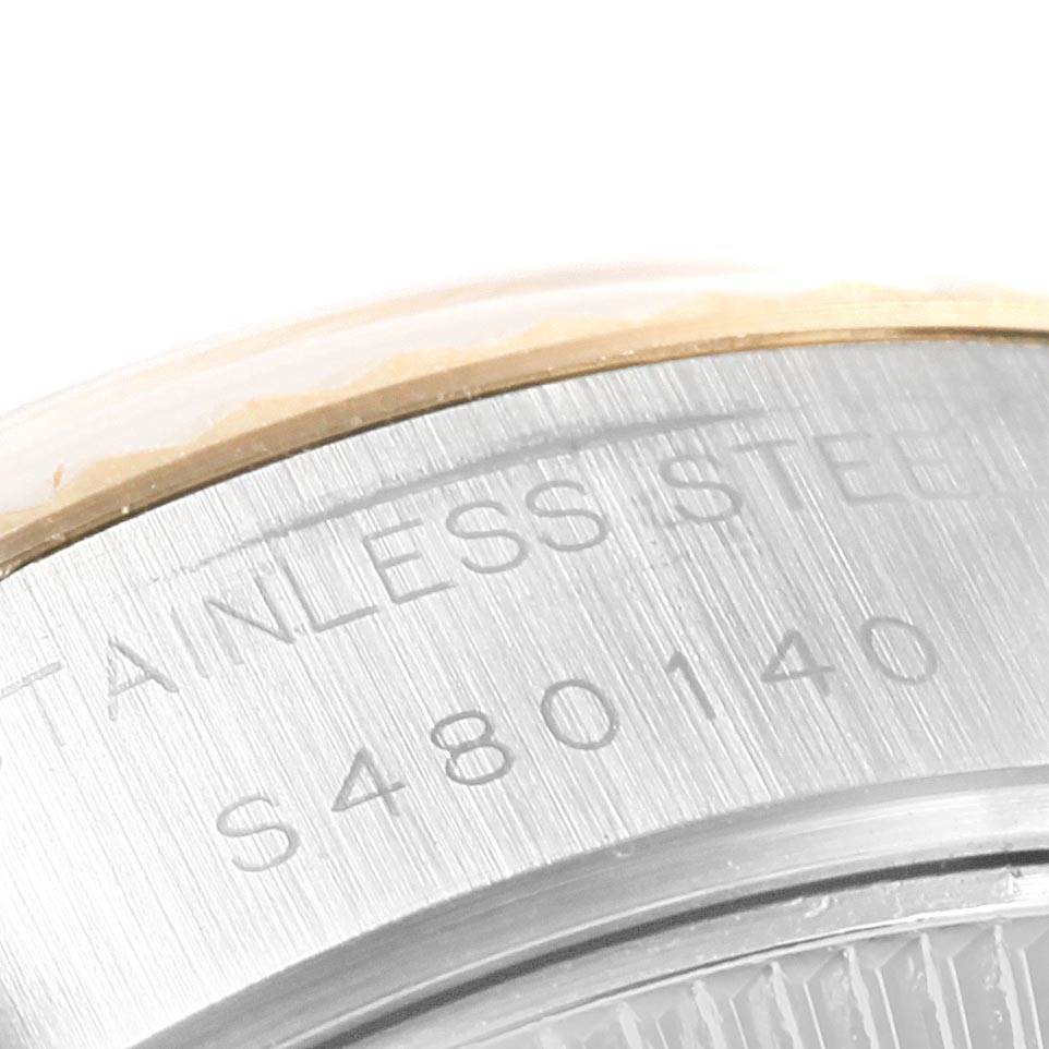 This close-up image shows the stainless steel case and serial number of a Rolex Datejust 69173 Women's Stainless Steel Champagne Dial 69173 Women's Stainless Steel Champagne Dial watch.