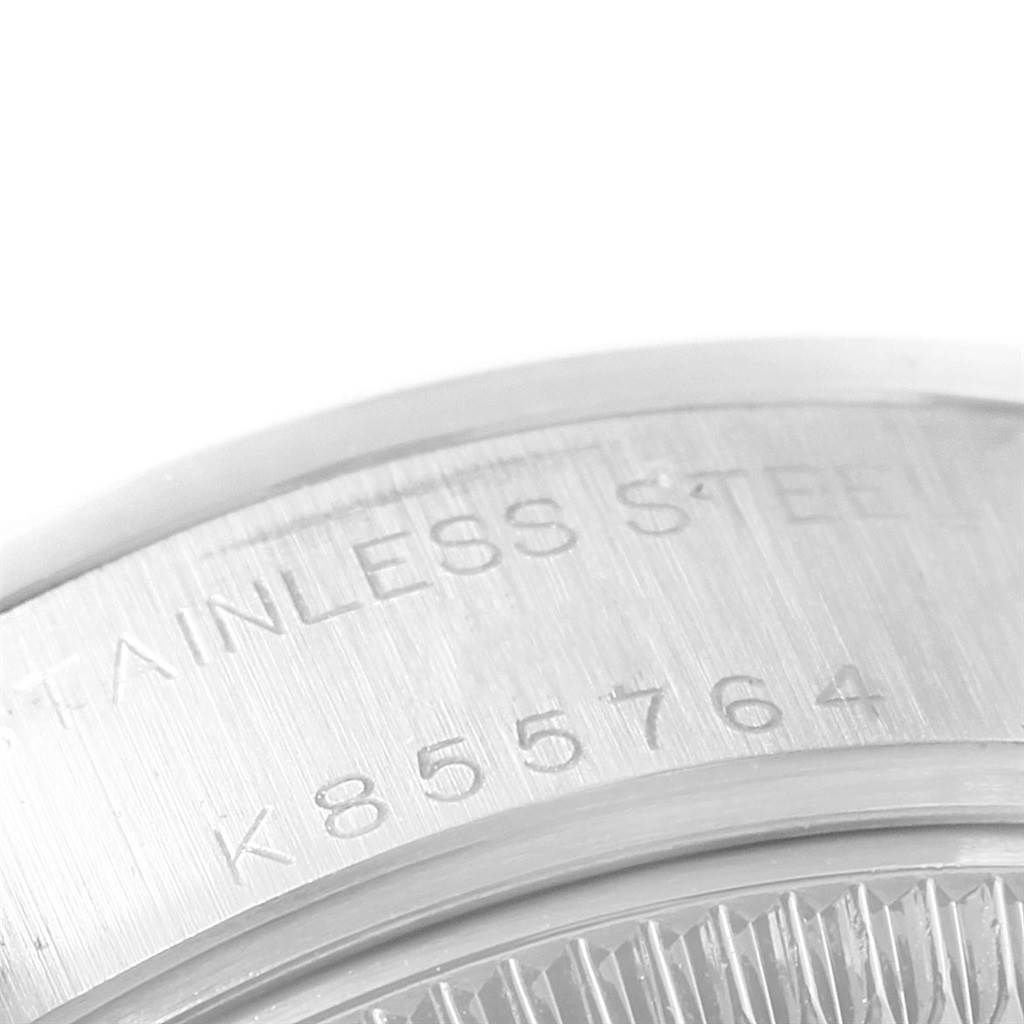 This image shows a close-up of the case back engraving on a Datejust model by Rolex, highlighting the serial number and stainless steel material.